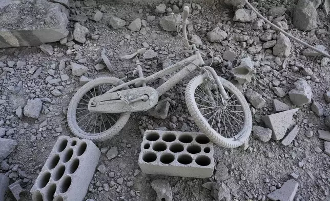 A damaged bicycle on the ground inside a building that was hit by an Israeli airstrike in Baalbek, east Lebanon, Monday, Oct. 7, 2024. (AP Photo/Hassan Ammar)