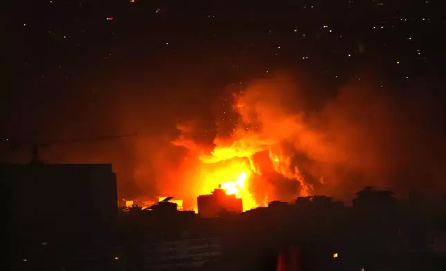 Flames and smoke rise from an Israeli airstrike in Dahiyeh, Beirut, Lebanon, early Sunday, Oct. 6, 2024. (AP Photo/Hussein Malla)