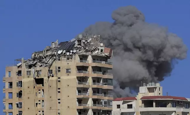 Smoke rises from a building hit in an Israeli airstrike in Tyre, Lebanon, Wednesday, Oct. 23, 2024. (AP Photo/Mohammad Zaatari)