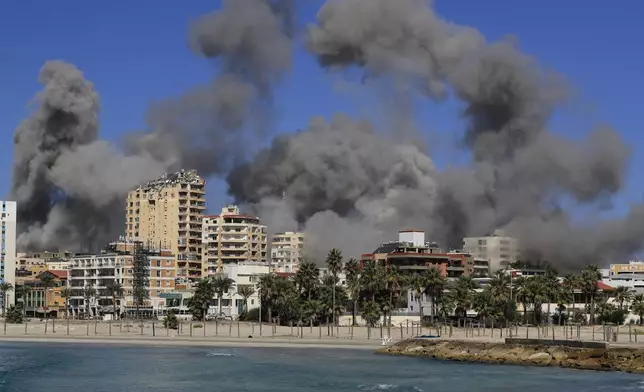 Smoke rises from buildings hit in Israeli airstrikes in Tyre, Lebanon, Wednesday, Oct. 23, 2024. (AP Photo/Mohammad Zaatari)