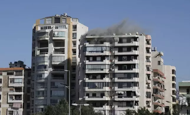 Smoke rises from a building following an Israeli warning strike, that came minutes before a bomb brought down the building, in Ghobeiri, Beirut, Lebanon, Tuesday, Oct. 22, 2024. (AP Photo/Bilal Hussein)