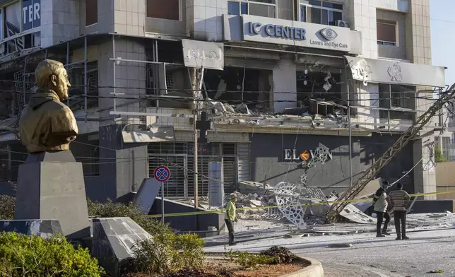 A bust of late Iranian General Qassem Soleimani, stands in front of a destroyed branch of the Hezbollah-run Qard al-Hassan at the site of an Israeli airstrike in Dahiyeh, Beirut, Lebanon, Monday, Oct. 21, 2024. (AP Photo/Hassan Ammar)