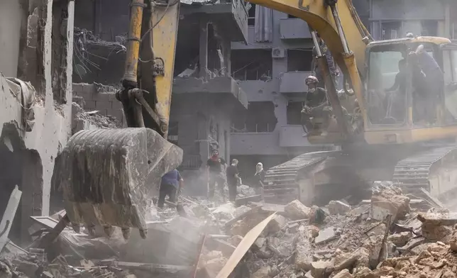 Rescue workers keep searching for victims at the site of Thursday's Israeli airstrike in Beirut, Lebanon, Saturday, Oct. 12, 2024. (AP Photo/Hassan Ammar)