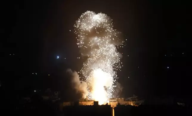 Flames and smoke rise from an Israeli airstrike in Dahiyeh, Beirut, Lebanon, early Sunday, Oct. 6, 2024. (AP Photo/Hussein Malla)