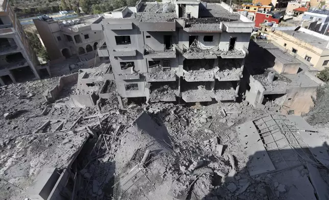 Destroyed buildings that were hit by Israeli airstrikes are seen in Qana village, south Lebanon, Wednesday, Oct. 16, 2024. (AP Photo/Mohammed Zaatari)