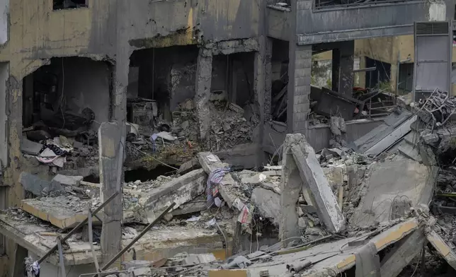 Destroyed buildings are seen after being hit by Israeli airstrikes in the village of Qmatiyeh, southeast Beirut, Lebanon, Monday, Oct. 7, 2024. (AP Photo/Bilal Hussein)