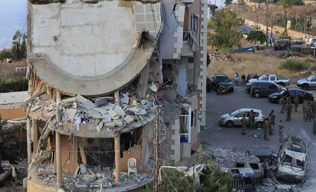 Lebanese army soldiers deploy around a destroyed building hit by an Israeli airstrike, in Barja village, south of Beirut, Lebanon, Saturday, Oct. 12, 2024. (AP Photo/Mohammed Zaatari)