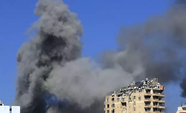 Smoke rises from buildings hit in Israeli airstrikes in Tyre, Lebanon, Wednesday, Oct. 23, 2024. (AP Photo/Mohammad Zaatari)