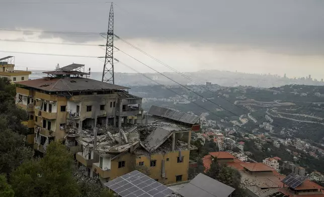 Destroyed buildings are seen after being hit by Israeli airstrikes in the village of Qmatiyeh, southeast Beirut, Lebanon, Monday, Oct. 7, 2024. (AP Photo/Bilal Hussein)