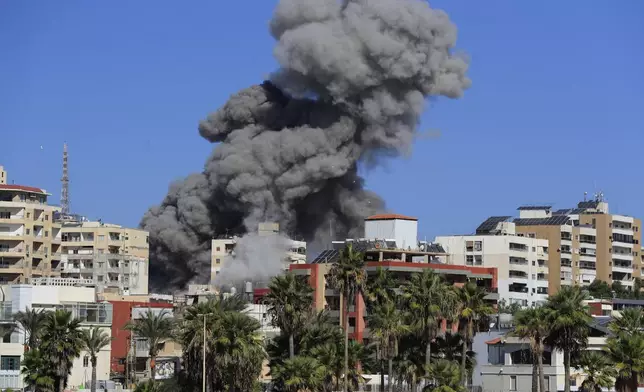 Smoke rises from buildings hit in an Israeli airstrike in Tyre, Lebanon, Wednesday, Oct. 23, 2024. (AP Photo/Mohammad Zaatari)