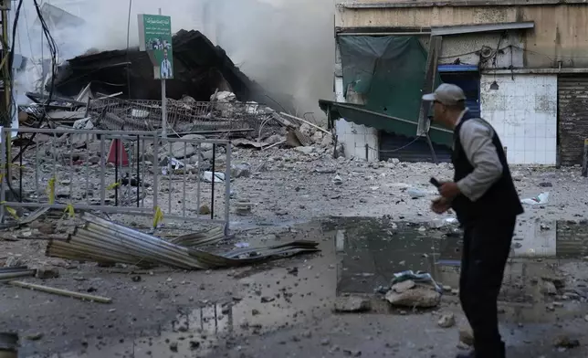 A man checks a destroyed building where he was living and which was hit by Israeli airstrike in Dahiyeh, Beirut, Lebanon, Sunday, Oct. 6, 2024. (AP Photo/Hussein Malla)