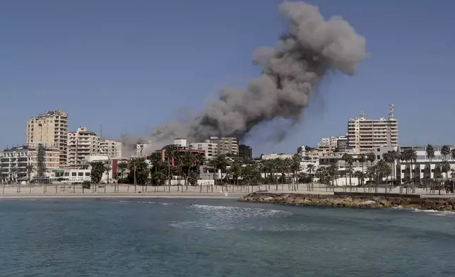 Smoke rises from buildings hit in an Israeli airstrike in Tyre, Lebanon, Wednesday, Oct. 23, 2024. (AP Photo/Mohammad Zaatari)