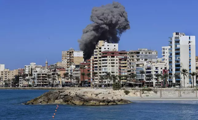 Smoke rises from buildings hit in an Israeli airstrike in Tyre, Lebanon, Wednesday, Oct. 23, 2024. (AP Photo/Mohammad Zaatari)