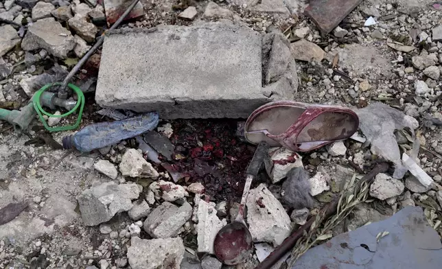 The blood of killed people on the rubble of a destroyed building at the site of Monday's Israeli airstrike in Aito village, north Lebanon, Tuesday, Oct. 15, 2024. (AP Photo/Hussein Malla)