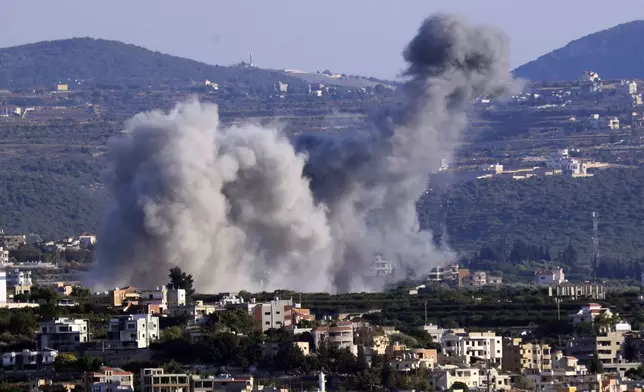 Smoke rises from an Israeli airstrike on Majdal Zoun village, in this view from the southern city of Tyre, south Lebanon, Thursday, Oct. 24, 2024. (AP Photo/Mohammed Zaatari)