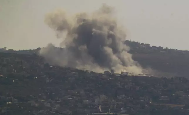 Smoke rises from an Israeli airstrike on Mansouri village, as it seen from the southern city of Tyre, south Lebanon, Thursday, Oct. 24, 2024. (AP Photo/Mohammed Zaatari)