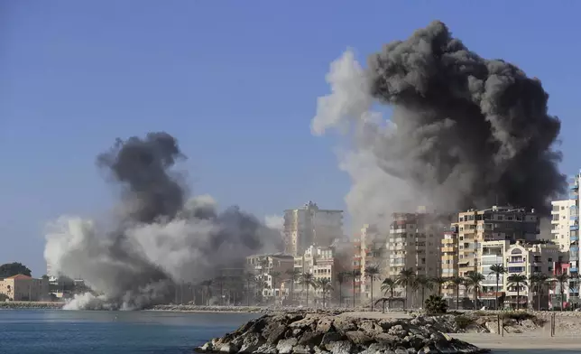 Smoke rises from buildings hit in Israeli airstrikes in Tyre, southern Lebanon, Monday, Oct. 28, 2024. (AP Photo/Mohammad Zaatari)