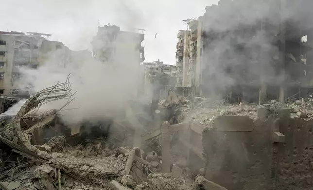 Smoke rises from destroyed buildings at the site of an Israeli airstrike hit in Choueifat, southeast of Beirut, Lebanon, Monday, Oct. 7, 2024. (AP Photo/Bilal Hussein)