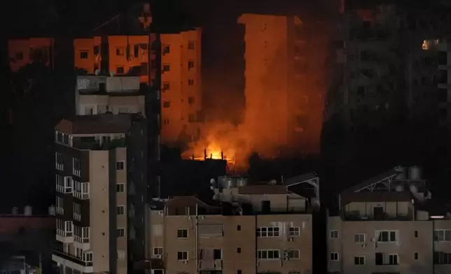 Flame rise from a past Israeli airstrike on Dahiyeh, in the southern suburb of Beirut, Lebanon, early Friday, Oct. 25, 2024. (AP Photo/Hussein Malla)