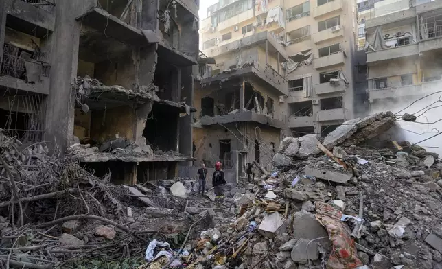 Rescue workers search for victims at the site of Thursday's Israeli airstrike in Beirut, Lebanon, Friday, Oct. 11, 2024. (AP Photo/Hassan Ammar)