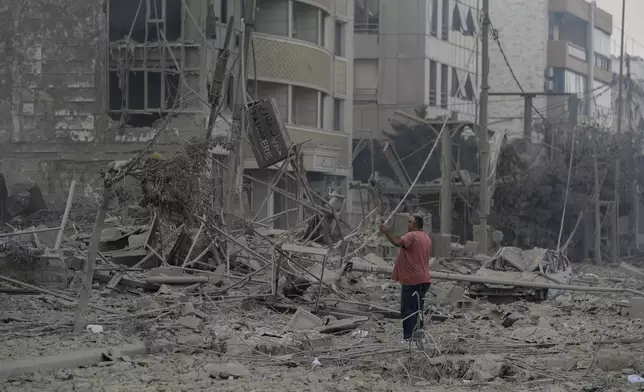 A man checks the site of an Israeli airstrike in Dahiyeh, Beirut, Lebanon, Sunday, Oct. 6, 2024. (AP Photo/Bilal Hussein)