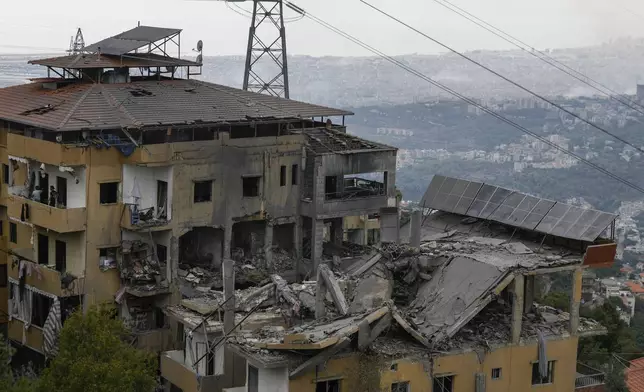 Destroyed buildings are seen after being hit by Israeli airstrikes in the village of Qmatiyeh, southeast Beirut, Lebanon, Monday, Oct. 7, 2024. (AP Photo/Bilal Hussein)