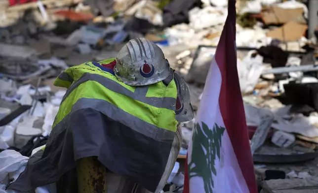 Hezbollah paramedic stuff left on the debris after an airstrike hit an apartment in a multistory building, in central Beirut, Lebanon, Thursday, Oct. 3, 2024. (AP Photo/Hussein Malla)