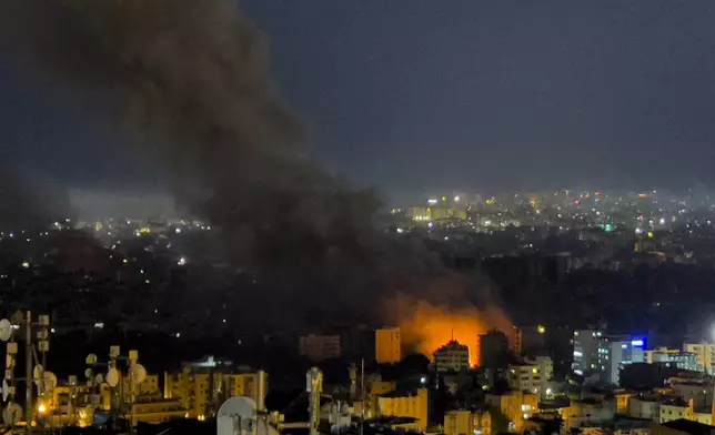 Flames and smoke rise from Israeli airstrikes in Dahiyeh, Beirut, Lebanon, Friday, Oct. 4, 2024. (AP Photo/Hussein Malla)