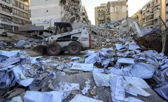 Documents of Hezbollah-run al-Qard al-Hassan are scattered at the site of an Israeli airstrike on Sunday night in Beirut's southern suburb, Lebanon, Monday, Oct. 21, 2024. (AP Photo/Hassan Ammar)