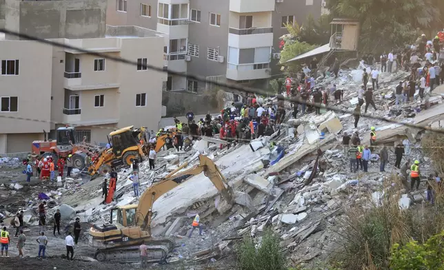 FILE - People and rescue teams search for victims after an Israeli airstrike hit two adjacent buildings, in Ain el-Delb neighbourhood east of the southern port city of Sidon, Lebanon, Sunday, Sept. 29, 2024. (AP Photo/Mohammed Zaatari, File)