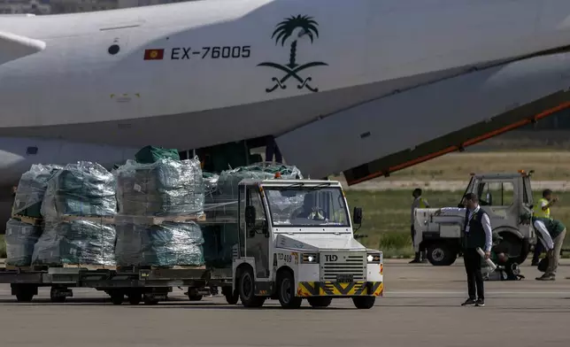 Workers unload Saudi medical aid boxes arriving at Beirut International airport, Lebanon, Sunday, Oct. 13, 2024. (AP Photo/Bilal Hussein)