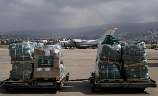 Workers unload Saudi medical aid boxes arriving at Beirut International airport, Lebanon, Sunday, Oct. 13, 2024. (AP Photo/Bilal Hussein)