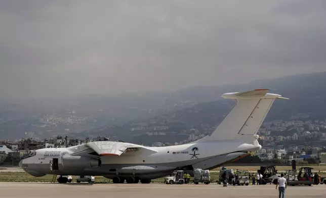 Workers unload Saudi medical aid boxes arriving at Beirut International airport, Lebanon, Sunday, Oct. 13, 2024. (AP Photo/Bilal Hussein)