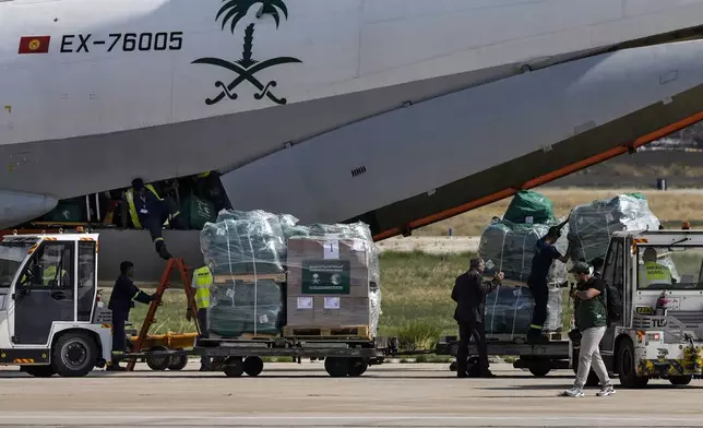 Workers unload Saudi medical aid boxes arriving at the Beirut International airport, Lebanon, Sunday, Oct. 13, 2024. (AP Photo/Bilal Hussein)