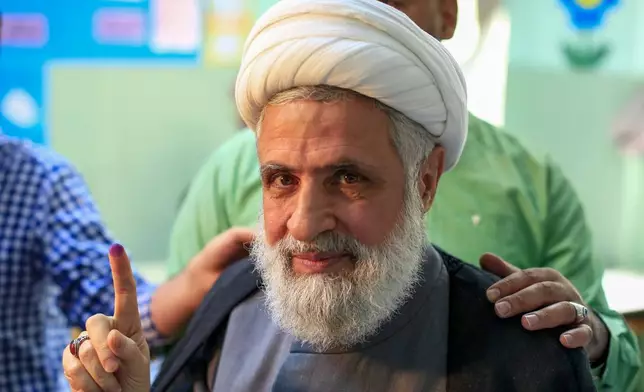 FILE - Hezbollah's deputy leader, Sheikh Naim Kassem, raises his finger after casting his vote during Lebanon's parliamentary elections in Beirut, Sunday, May 6, 2018. (AP Photo/Hassan Ammar, File)