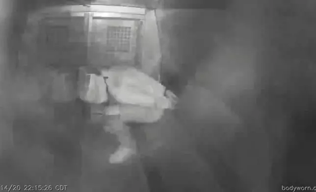 This image from Evansville Police Department video shows Evan Terhune, hands cuffed behind his back and his face covered by a spit hood, in the back of a police van in Evansville, Ind., on Nov. 14, 2020. By the time officers opened the van, he was unresponsive. (Evansville Police Department via AP)