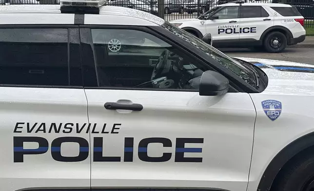 Evansville Police vehicles are parked on a street in Evansville, Ind., on June 4, 2024. (AP Photo/Ryan J. Foley)