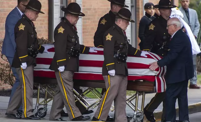 The casket of Vanderburgh County Sheriff's Deputy Asson Hacker is escorted to a hearse outside Boone Funeral Home in Evansville, Ind., on March 9, 2023. (MaCabe Brown/Evansville Courier &amp; Press via AP)