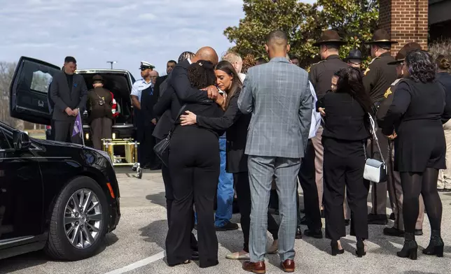 Friends and family of Vanderburgh County Sheriff's Deputy Asson Hacker gather after the procession arrives at Christian Fellowship Church in Evansville, Ind., for his visitation and funeral, on March 9, 2023. (MaCabe Brown/Evansville Courier &amp; Press via AP)