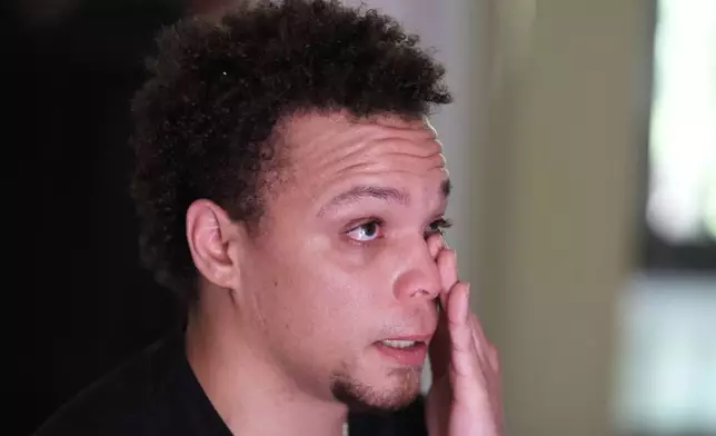 Lij Hacker wipes away a tear while talking about his late brother, Asson Hacker, during an interview in Bloomington, Ind., on June 4, 2024. (AP Photo/Darron Cummings)