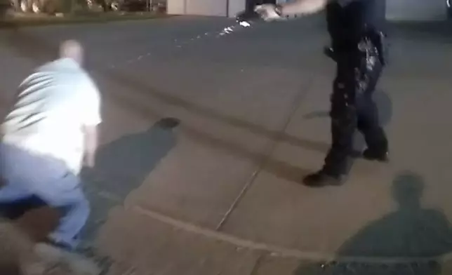 In this image from video provided by the Evansville Police Department, Officer Matthew Taylor fires a Taser at Edward Snukis in Evansville, Ind., on Sept. 13, 2019. Snukis, 55, died after an encounter in which officers shocked him with a Taser, punched him and held him face down. (Evansville Police Department via AP)