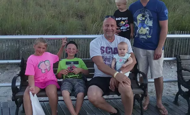 This photo provided by the family shows Edward Snukis, center, with four of his grandchildren and his son, Ed Snukis Jr., during a trip to Atlantic City, N.J., on Sept. 3, 2019. Snukis died later in the month after police officers in Evansville, Ind., shocked him with a Taser, punched him and held him face down. (Jill Snukis via AP)