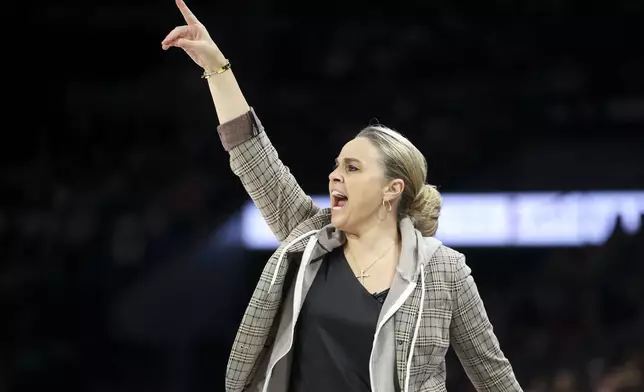 Las Vegas Aces head coach Becky Hammon yells during the first half of a WNBA Semifinal basketball game, Sunday, Oct. 6, 2024, in Las Vegas. (AP Photo/Ian Maule)