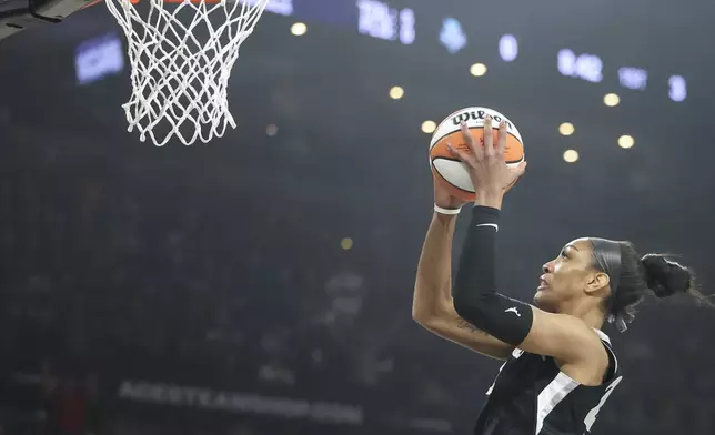 Las Vegas Aces center A'ja Wilson goes up for a basket during the first half of a WNBA Semifinal basketball game, Sunday, Oct. 6, 2024, in Las Vegas. (AP Photo/Ian Maule)