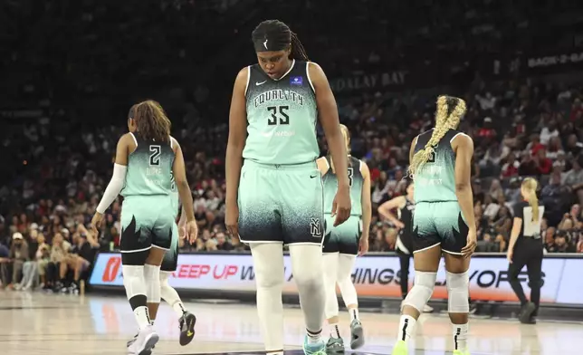 New York Liberty forward Jonquel Jones (35) lines up for teammate Kennedy Burke (2) to free-throw during a WNBA basketball semifinal game against Las Vegas Aces Friday, Oct. 4, 2024, in Las Vegas. (AP Photo/Ronda Churchill)