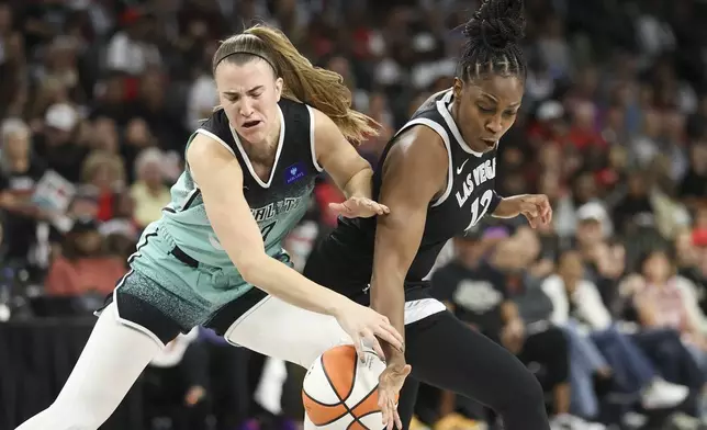 Las Vegas Aces guard Chelsea Gray knocks the ball away from New York Liberty guard Sabrina Ionescu (20) during the first half of a WNBA Semifinal basketball game, Sunday, Oct. 6, 2024, in Las Vegas. (AP Photo/Ian Maule)