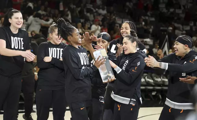 Las Vegas Aces guard Tiffany Hayes celebrates receiving the WMBA Sixth Player of the Year award prior to playing in a WNBA basketball semifinal game against New York Liberty Friday, Oct. 4, 2024, in Las Vegas. (AP Photo/Ronda Churchill)