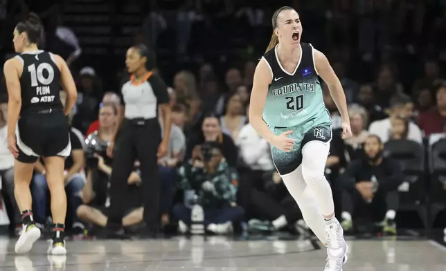 New York Liberty guard Sabrina Ionescu (20) reacts after a three-point- basket during the first half of a WNBA Semifinal basketball game, Sunday, Oct. 6, 2024, in Las Vegas. (AP Photo/Ian Maule)