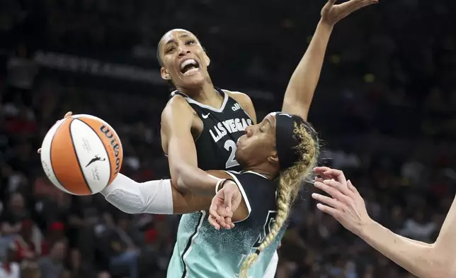 Las Vegas Aces center A'ja Wilson reacts while being fouled by New York Liberty forward Kayla Thornton during the first half of a WNBA Semifinal basketball game, Sunday, Oct. 6, 2024, in Las Vegas. (AP Photo/Ian Maule)