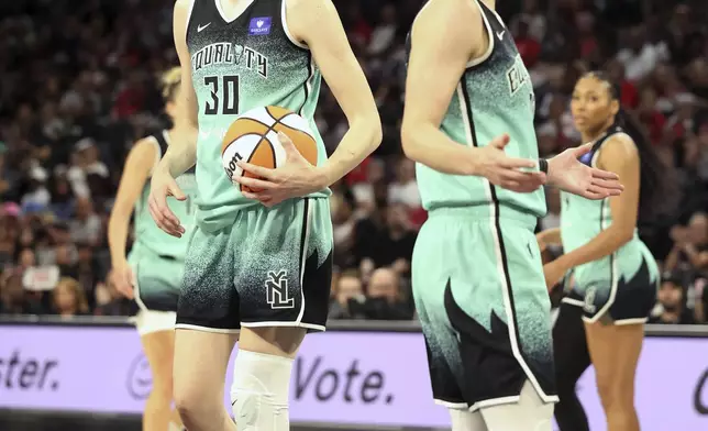 New York Liberty's forward Breanna Stewart (30) and guard Courtney Vandersloot, front right, react to a call during a WNBA basketball semifinal game against Las Vegas Aces, Friday, Oct. 4, 2024, in Las Vegas. (AP Photo/Ronda Churchill)